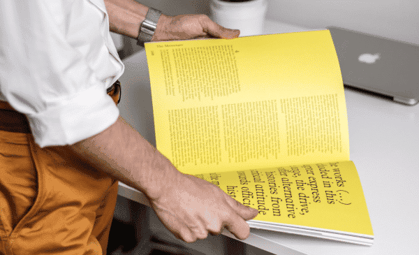 Person looking though a manual of printing terms.
